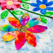Colorful flower-shaped art pieces on a textured white background