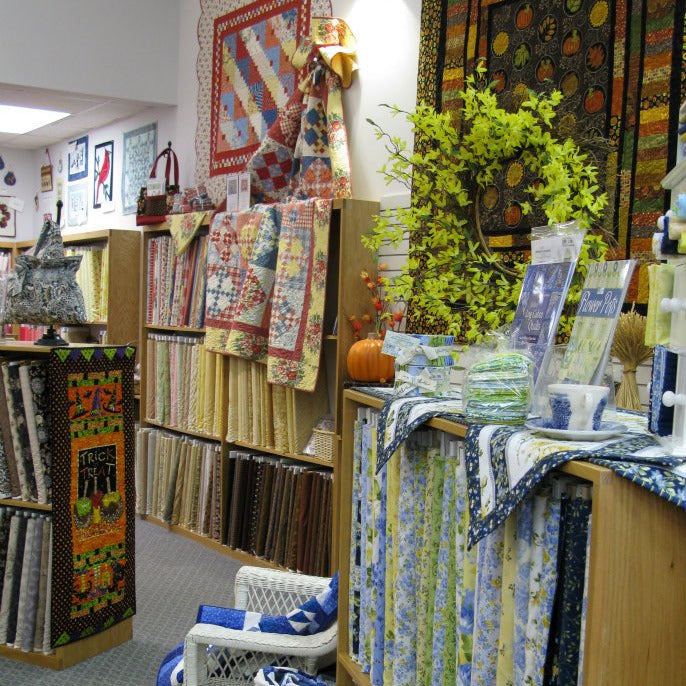 Quilt store interior with various quilts on display