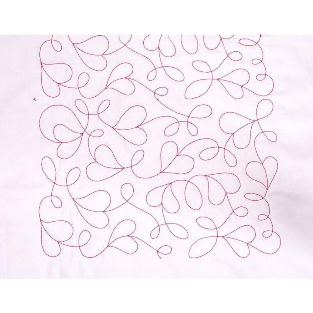 Quilt with red thread embroidery on a white background