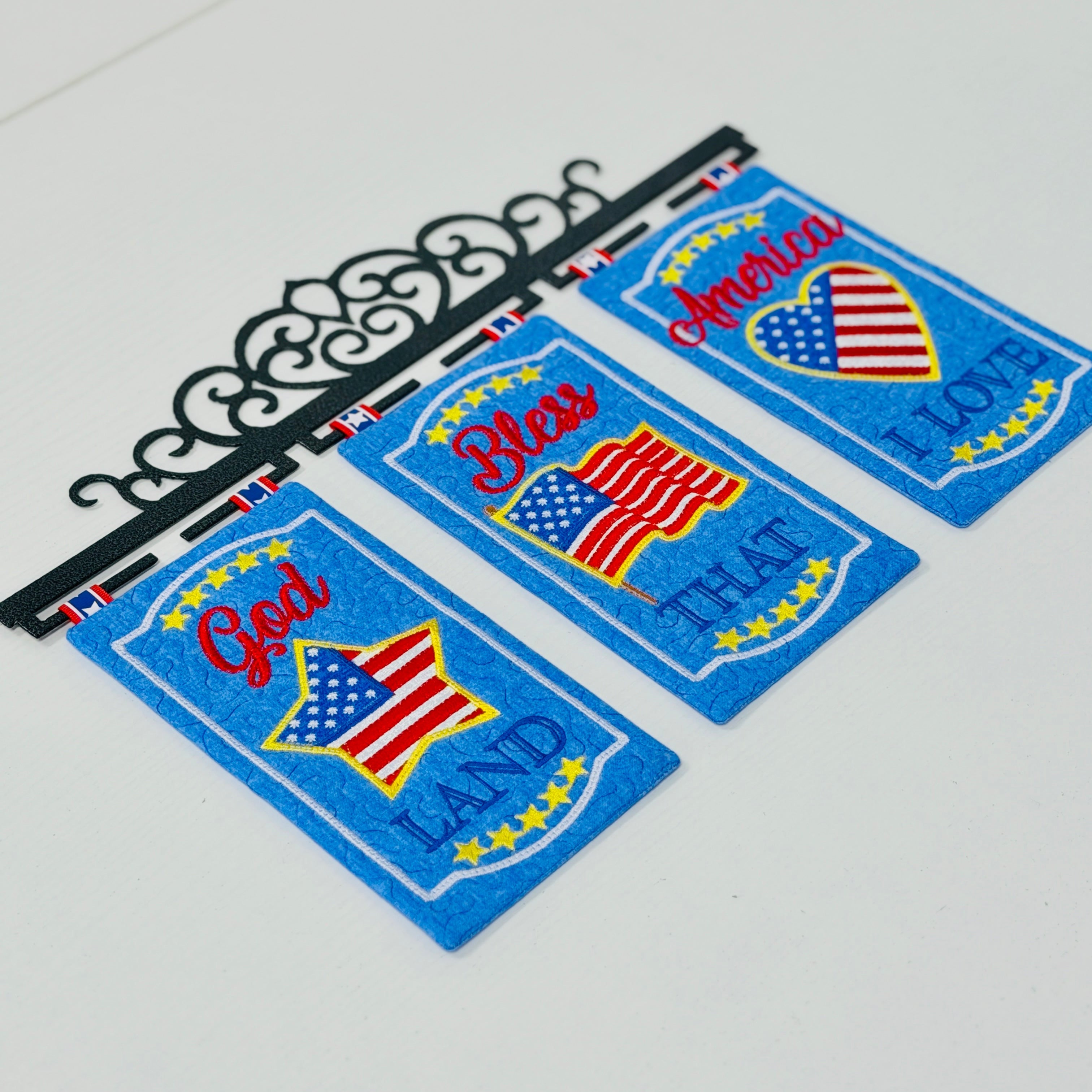 Three patriotic coasters with American flag design on a white surface.