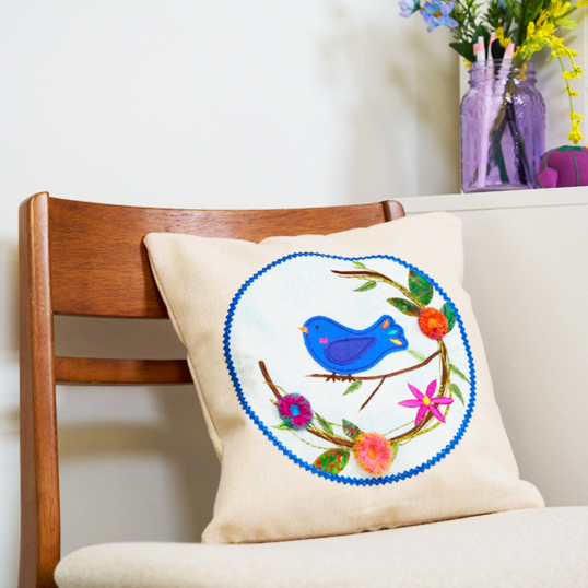Decorative pillow with a bird design on a chair