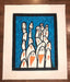 Quilt with penguin design on a blue background, displayed on a wooden surface.