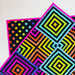 Colorful geometric patterned fabric with squares and polka dots on a white background