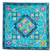 Colorful quilt with floral and geometric patterns on a blue background
