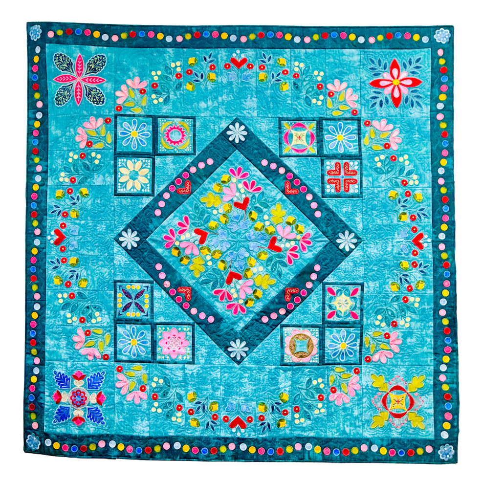 Colorful quilt with floral and geometric patterns on a blue background