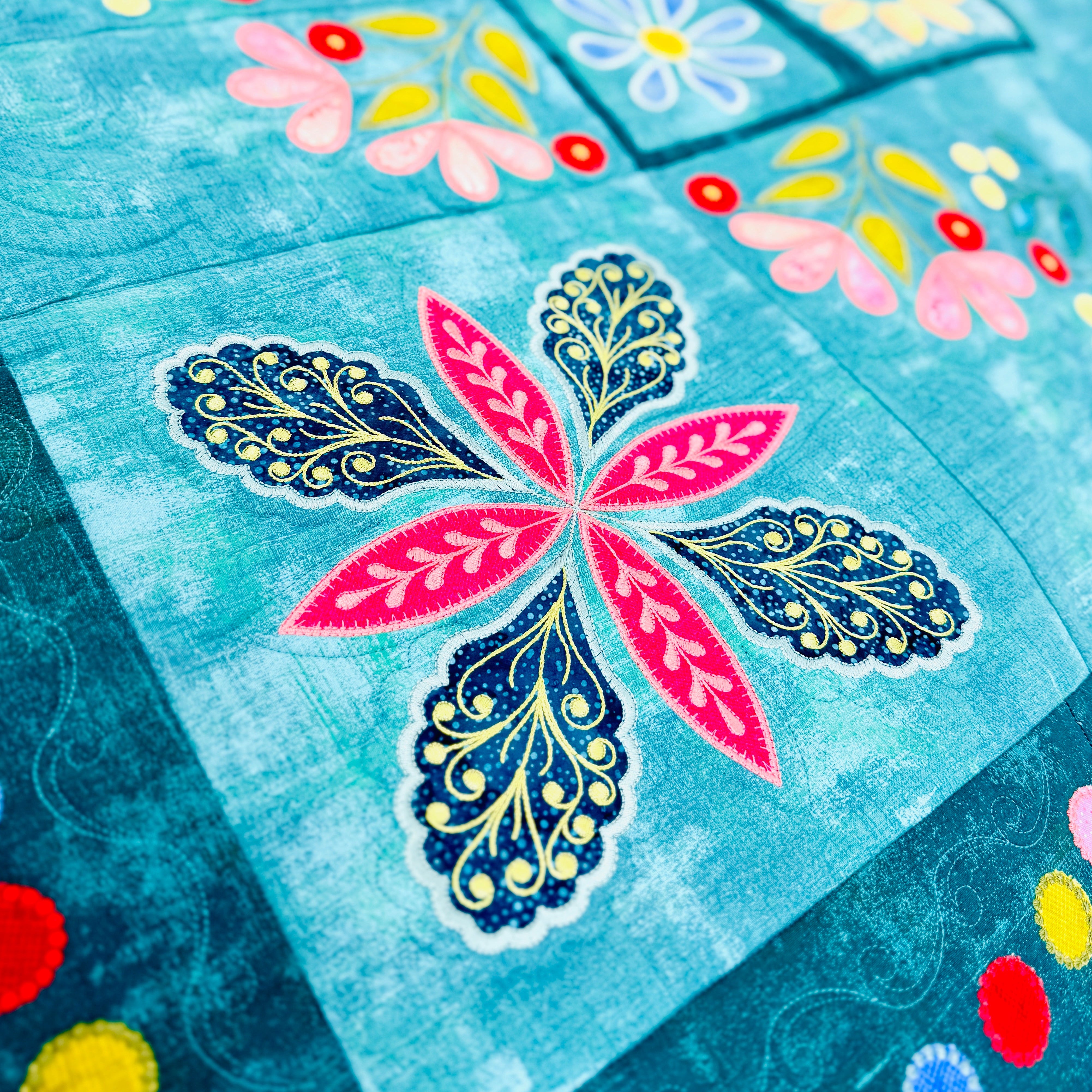 Colorful quilt with floral patterns on a blue background