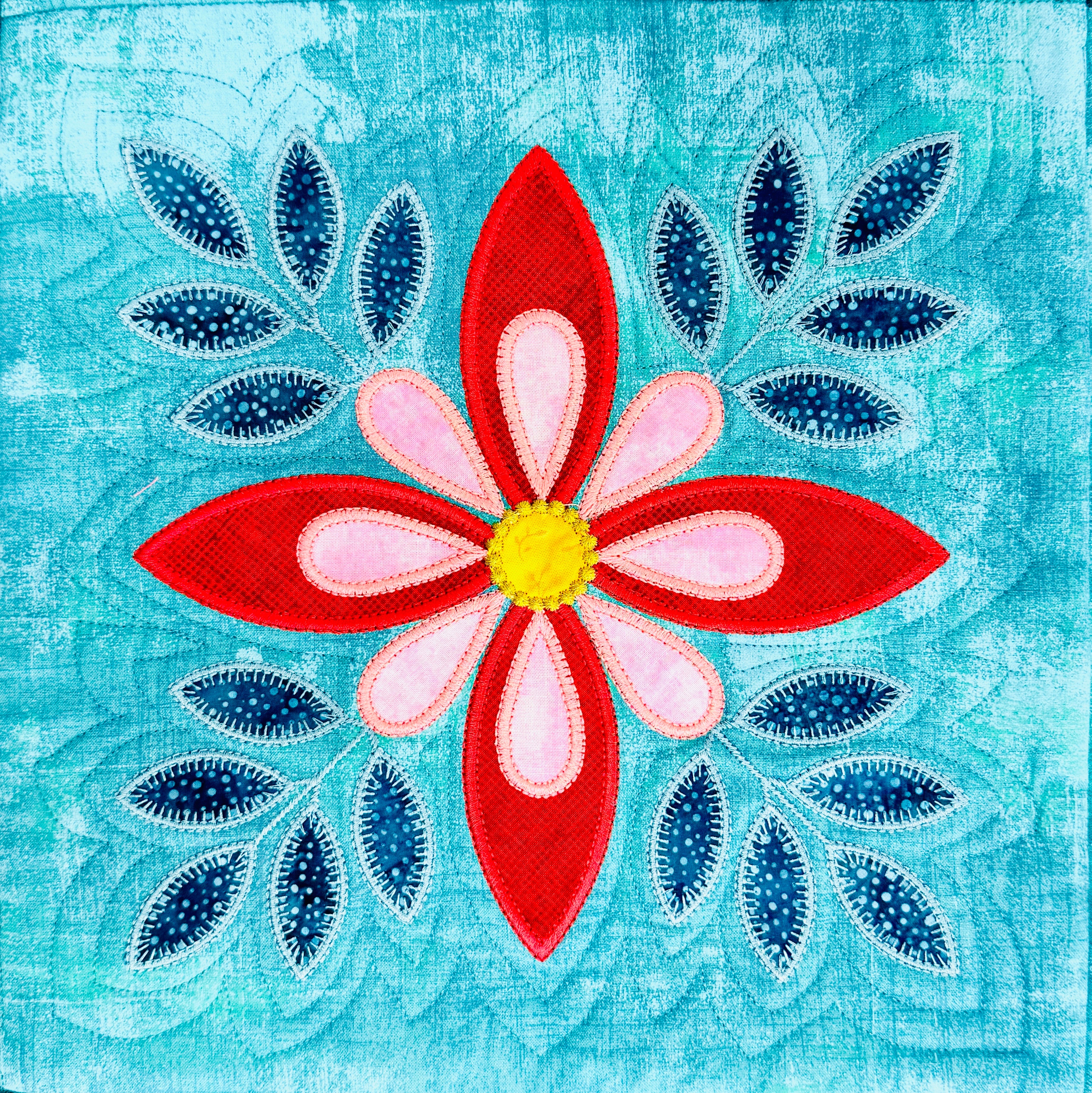 Decorative flower design with red and pink petals on a blue textured background