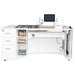 Sewing machine on a white desk with storage compartments.