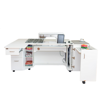 White sewing machine table with various items on a white background