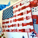 Quilt with American flag pattern displayed on a table.