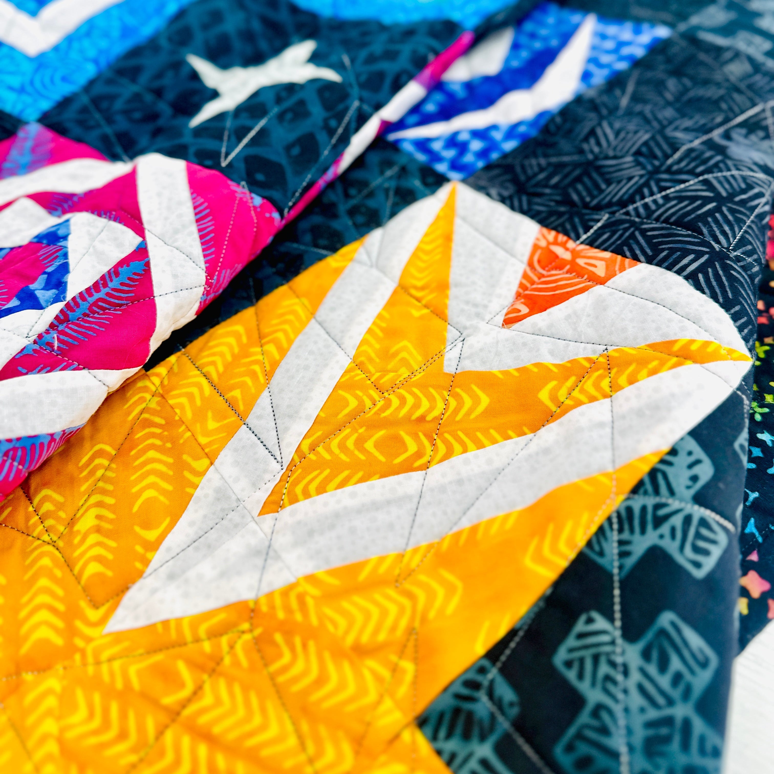 Close-up of a colorful quilt with geometric patterns