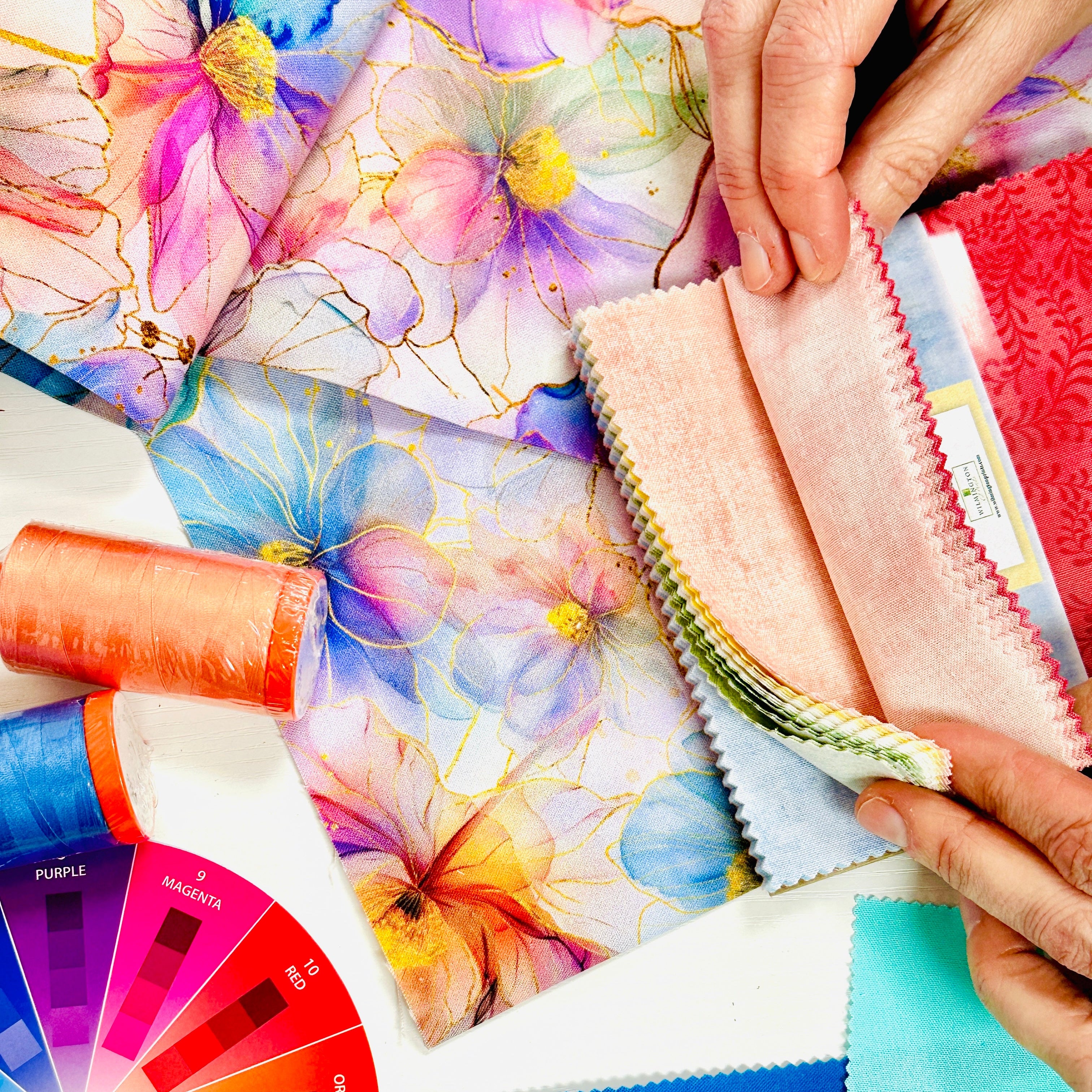 Color swatches and fabric samples with a color wheel on a table
