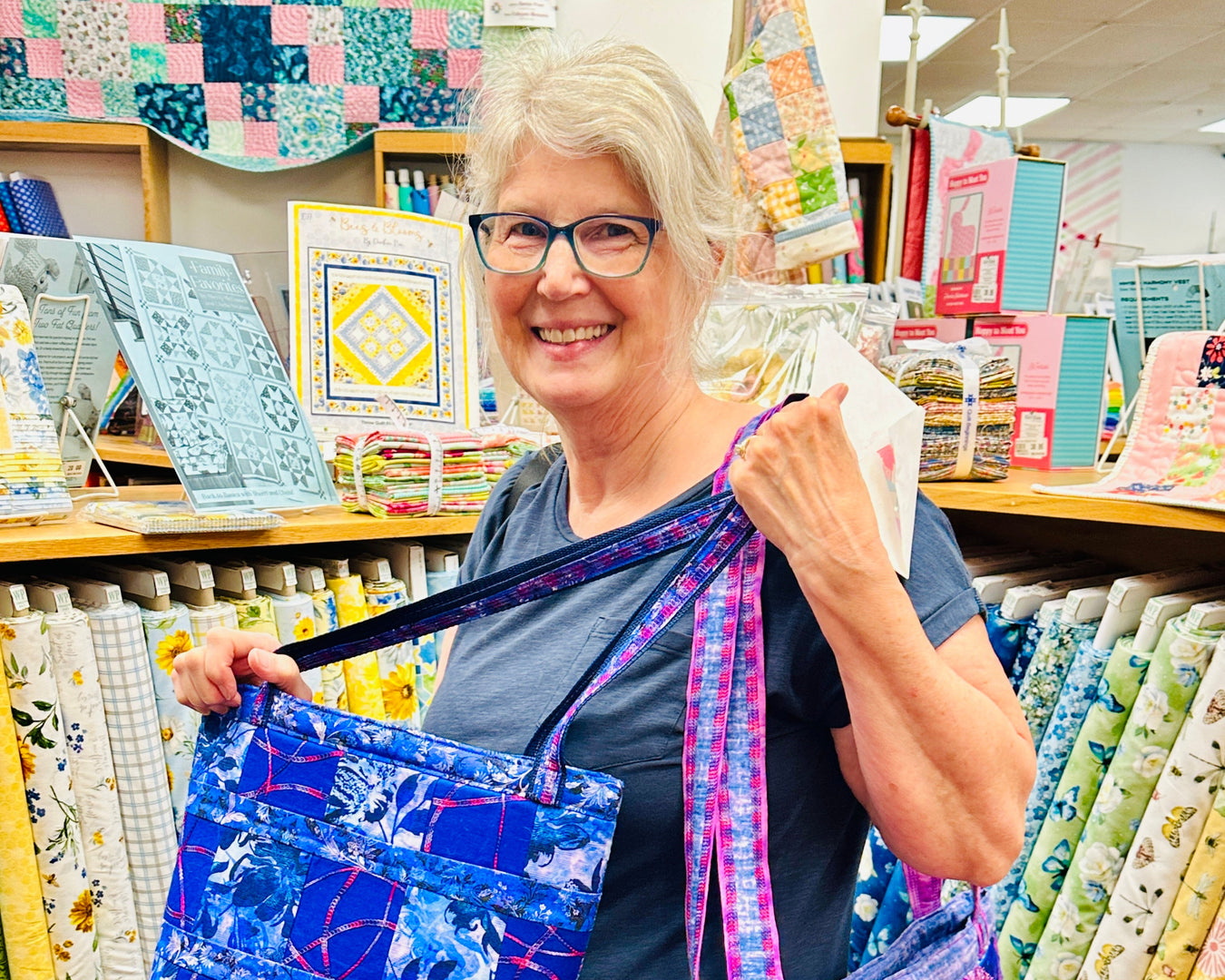 Woman holding a colorful bag in a fabric store