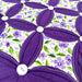 Close-up of a purple floral design with white buttons on a floral background