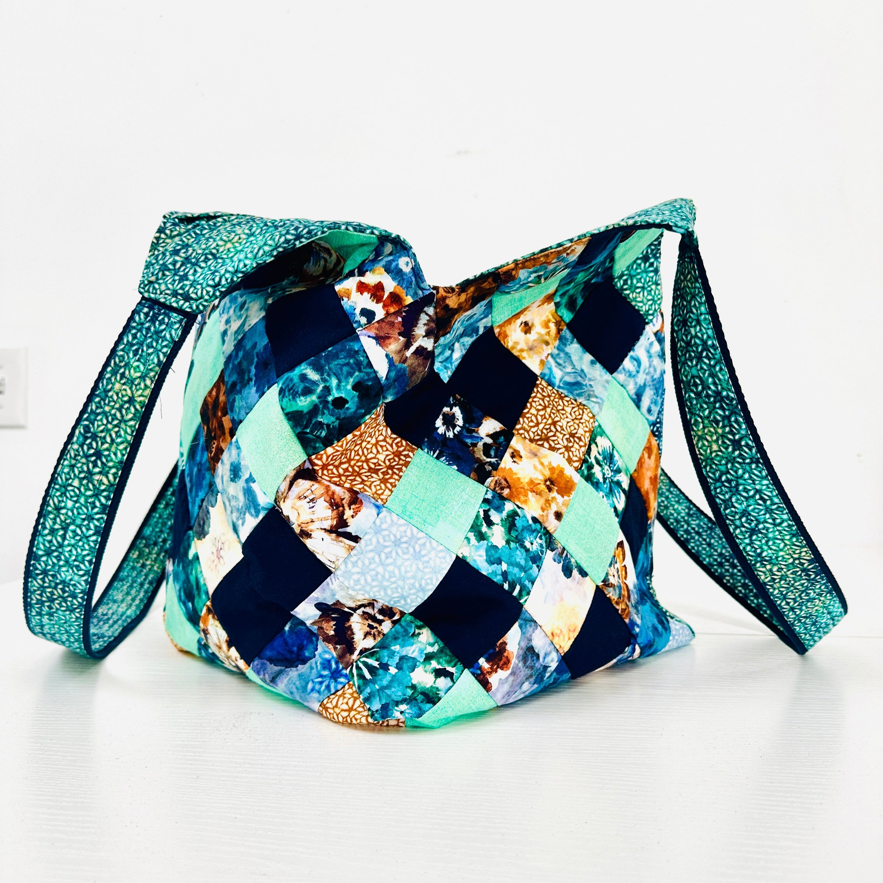 Multicolored patchwork bag with a strap on a white background