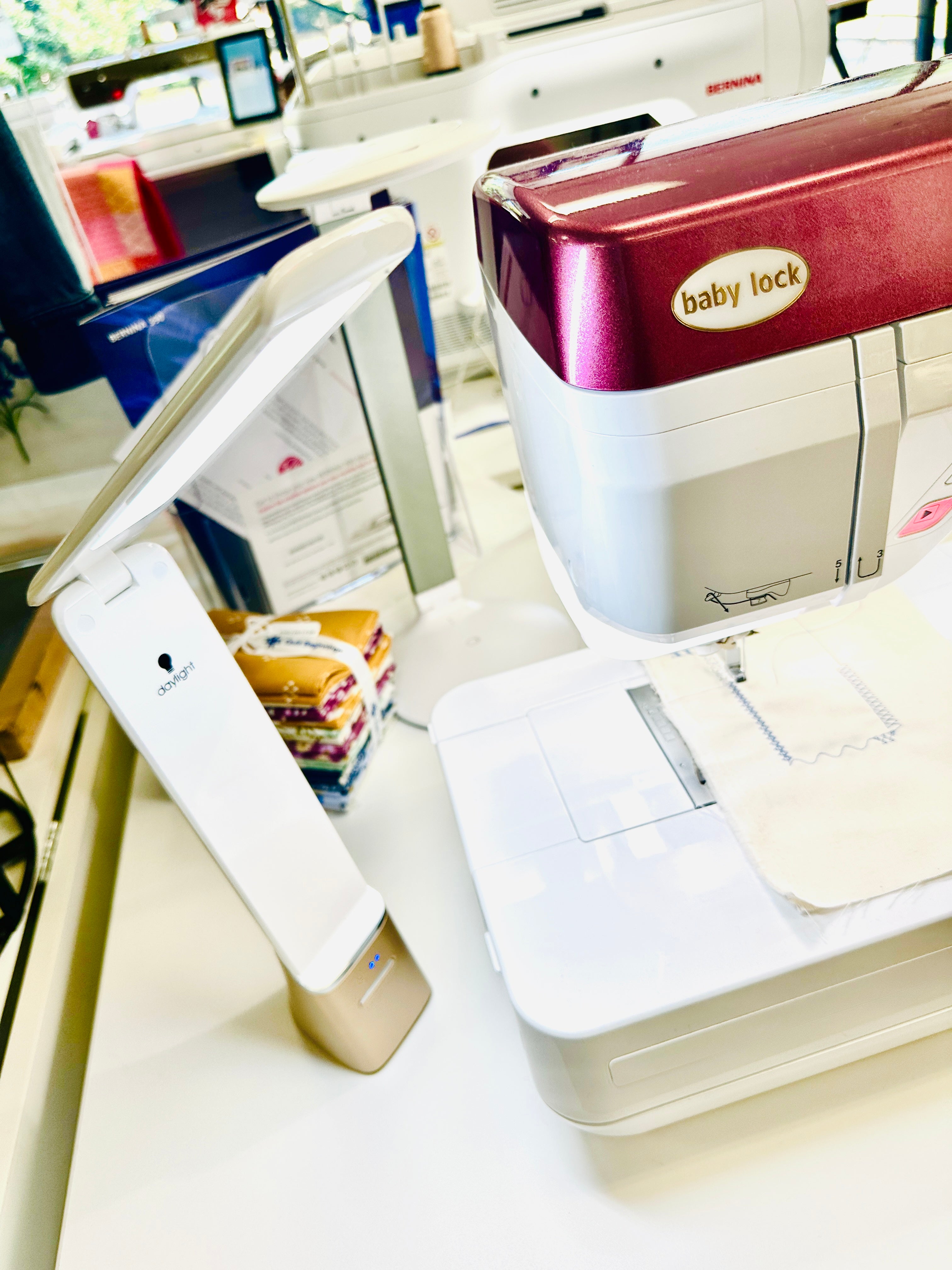 Baby Lock sewing machine on a table with a smartphone beside it