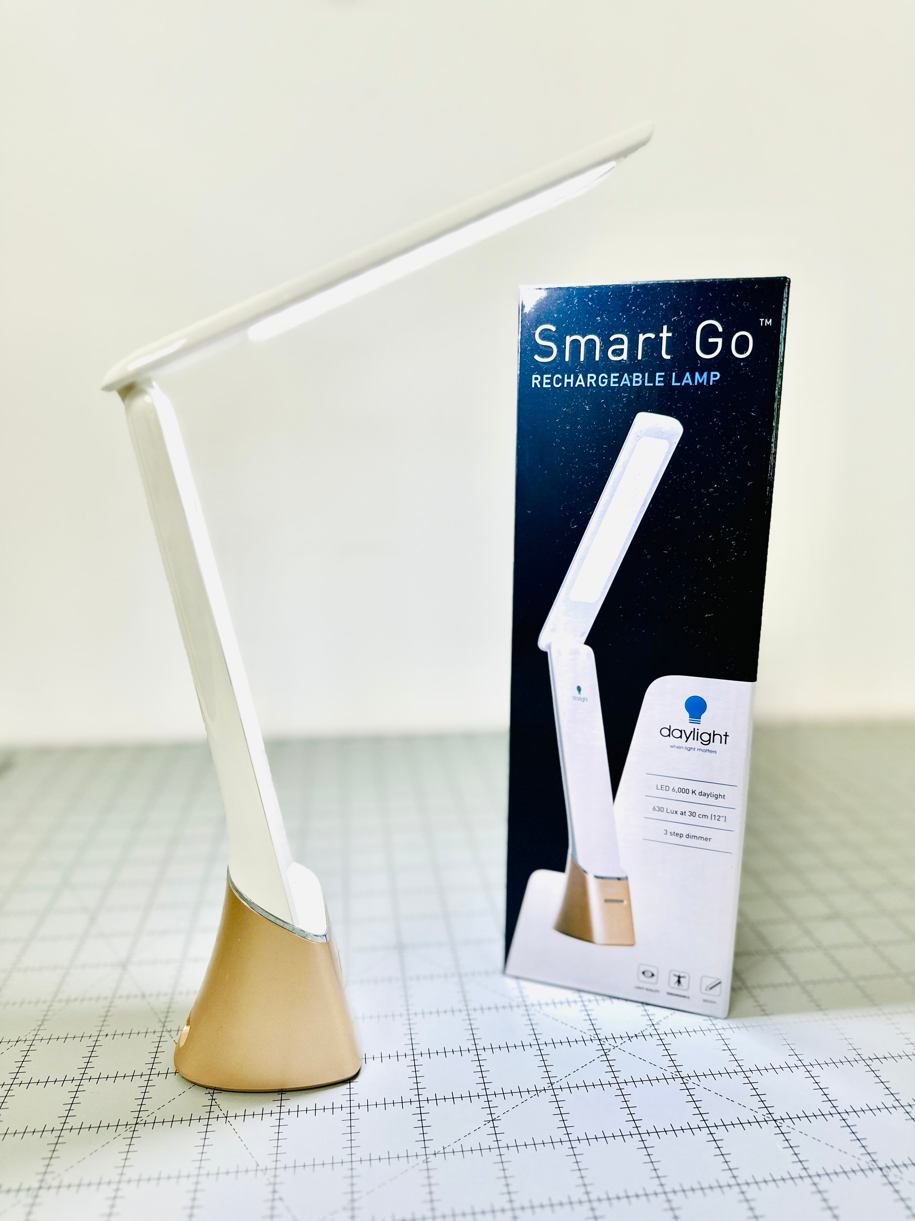 Smart Go rechargeable lamp with packaging on a grid background