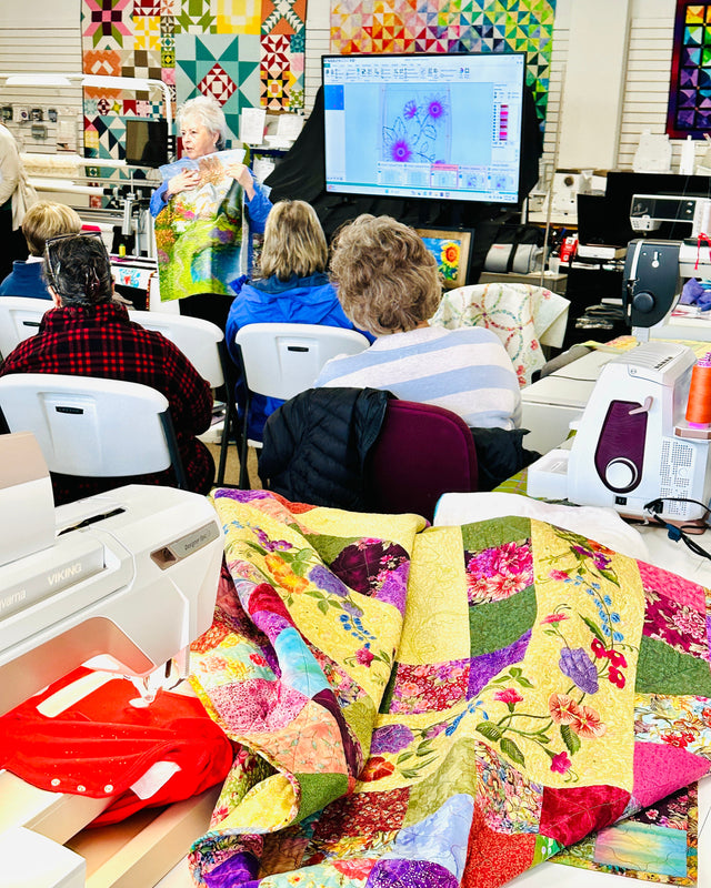 Quilt show with attendees and a display of colorful quilts.