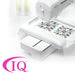 Embroidery machine with a floral design on a white background, featuring the IQ logo.
