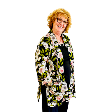 Woman wearing a floral patterned jacket on a white background