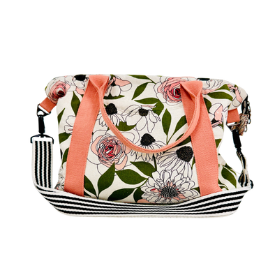 Floral patterned bag with pink straps on a white background