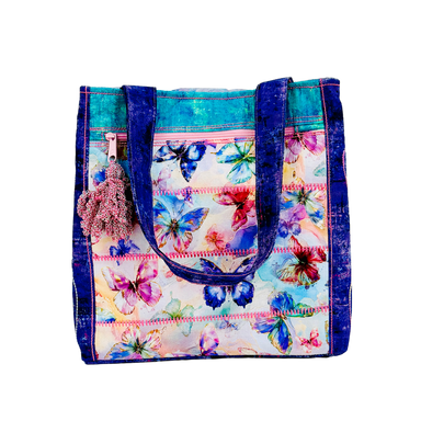 Colorful floral-patterned tote bag with blue accents on a white background