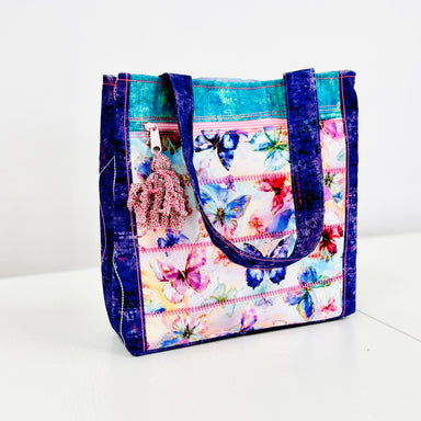 Colorful tote bag with butterfly pattern on a white background