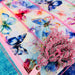 Quilt with butterfly pattern and pink zipper on a blue background