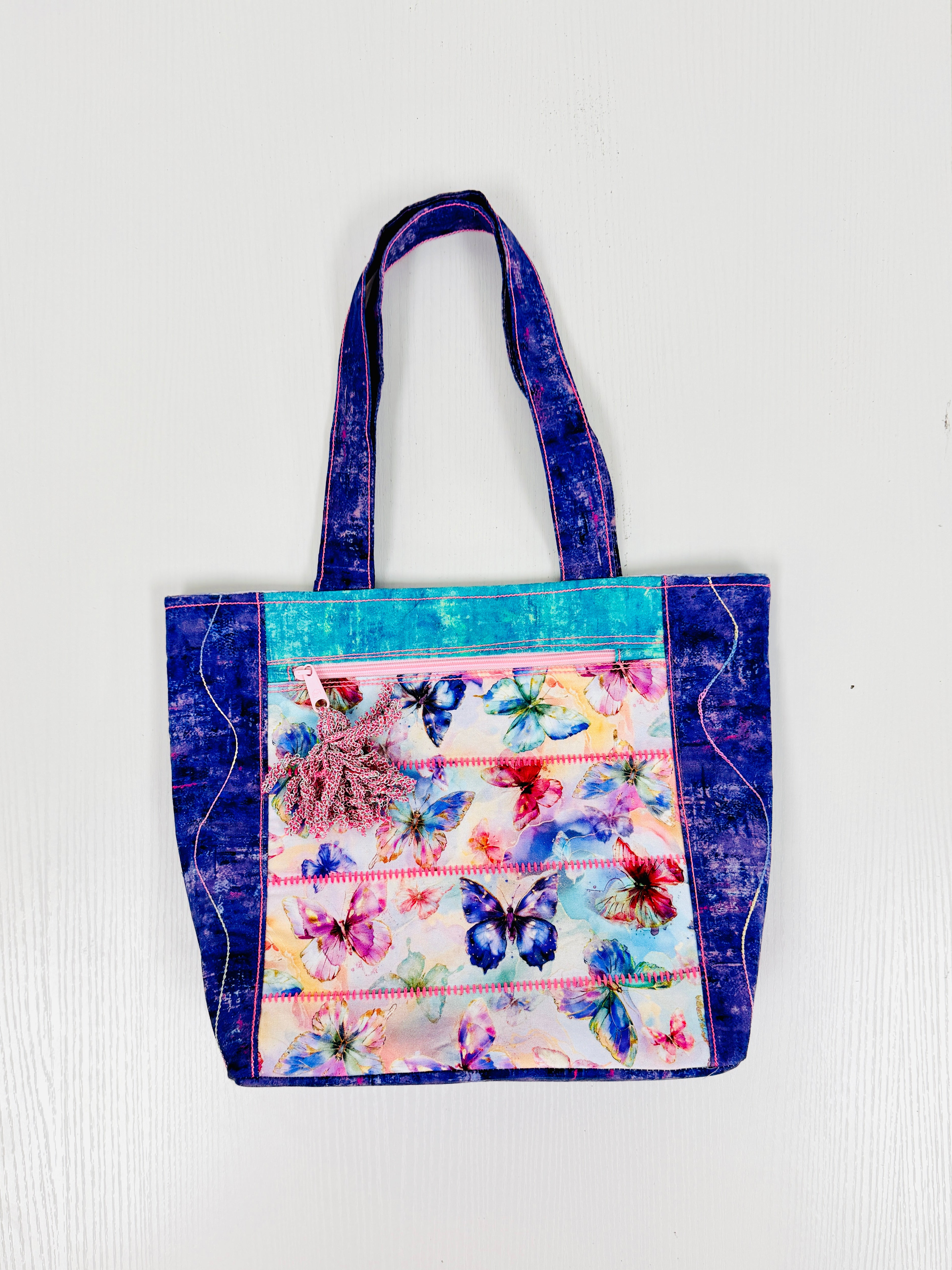 Tote bag with butterfly design on a white background
