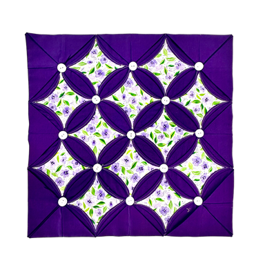 Purple floral patterned fabric with a white border on a white background