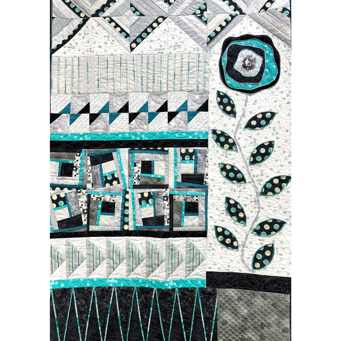 Bloom & Grow Serger Quilt with geometric patterns and a central floral design on a white background