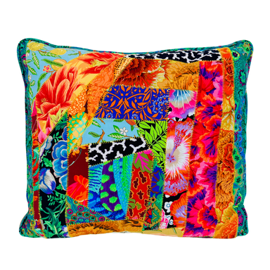 Colorful patchwork pillow with various patterns on a white background