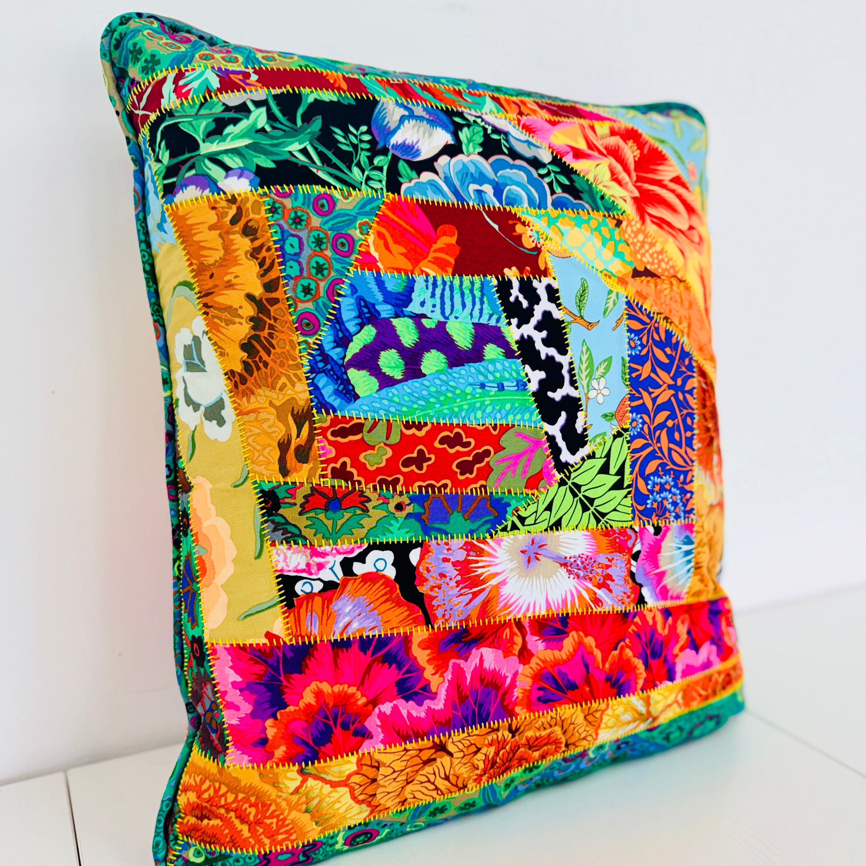 Colorful patchwork pillow on a white background