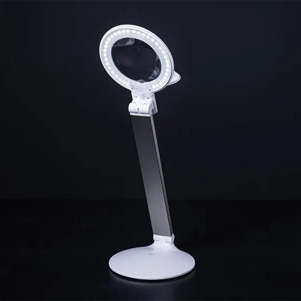 Magnifying glass with LED ring light on a black background