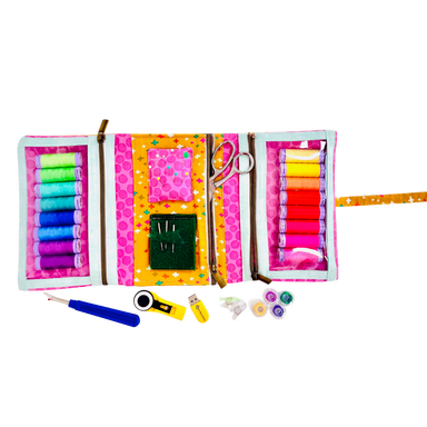 Colorful sewing kit with thread, scissors, and other tools on a white background