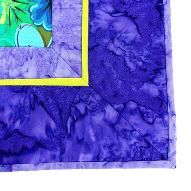 Close-up of a purple fabric with a floral pattern on a white background