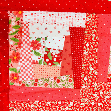 Patchwork quilt with red and floral patterns