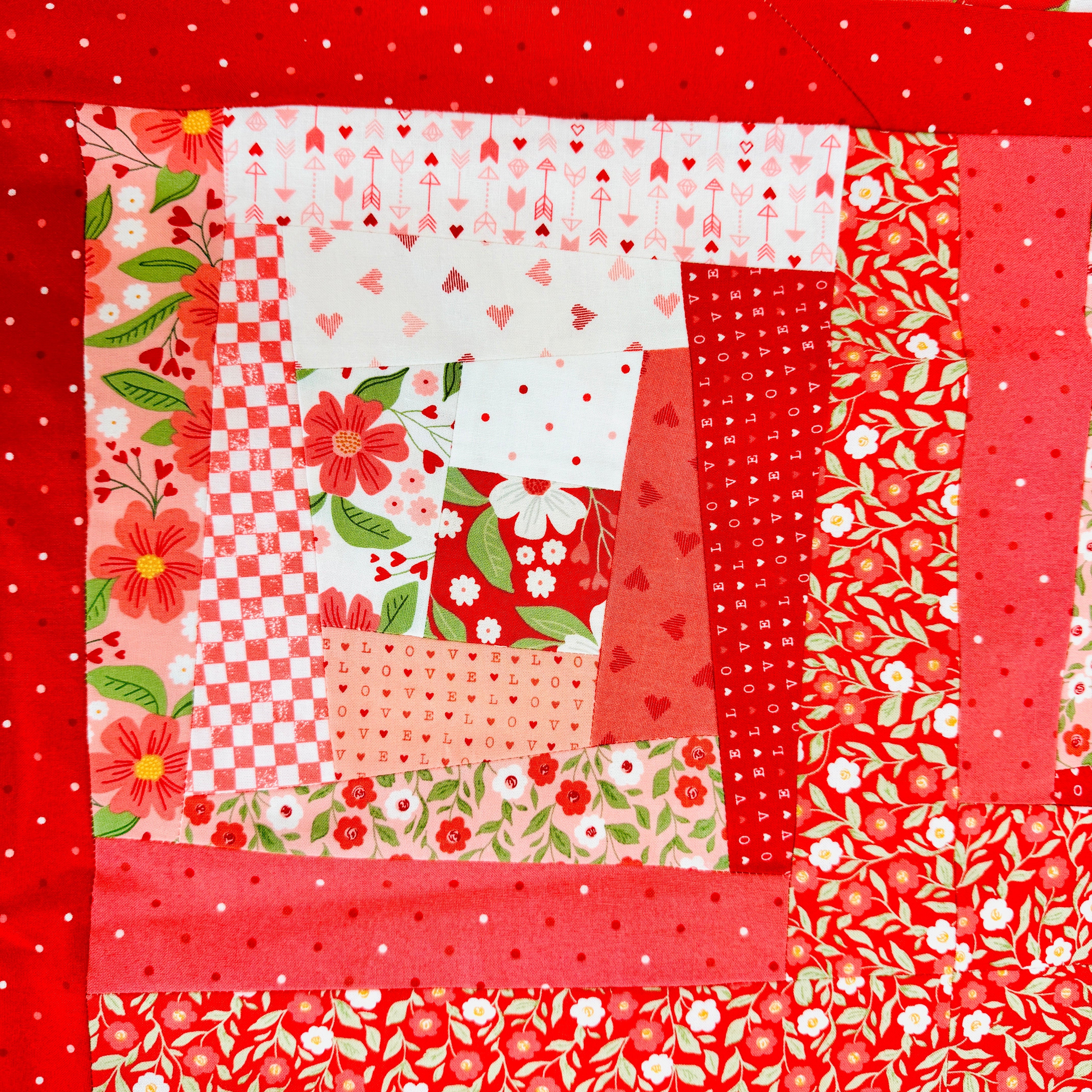 Patchwork quilt with red and floral patterns